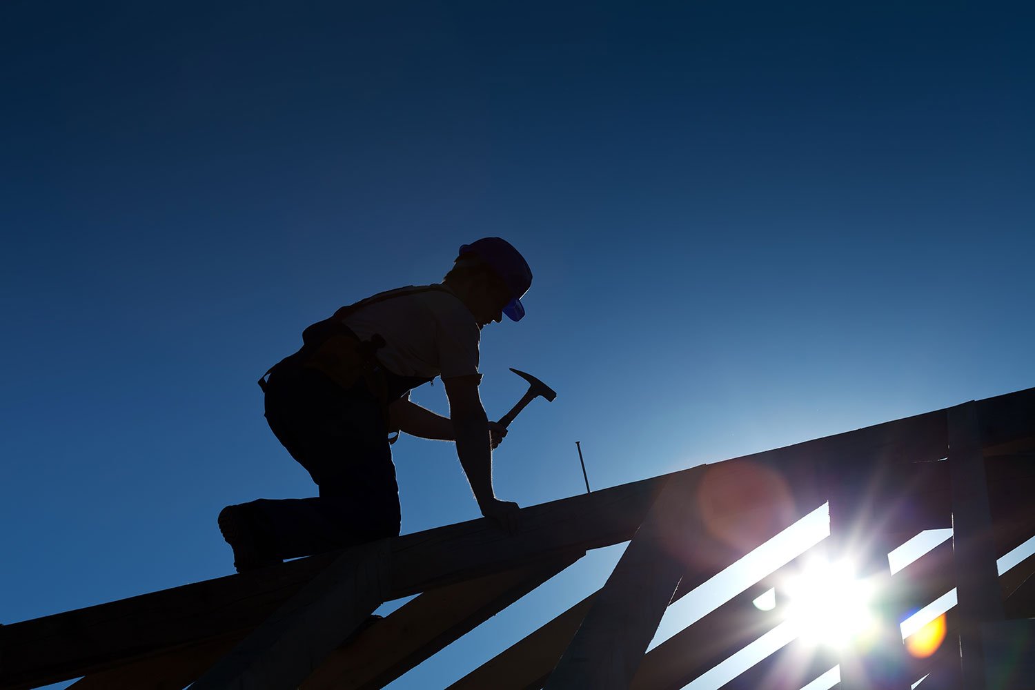 roofer putting installing roofing materials